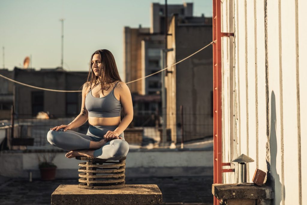 Une personne vapote à l’extérieur d’un studio de Pilates avant le cours, loin de l’entrée.